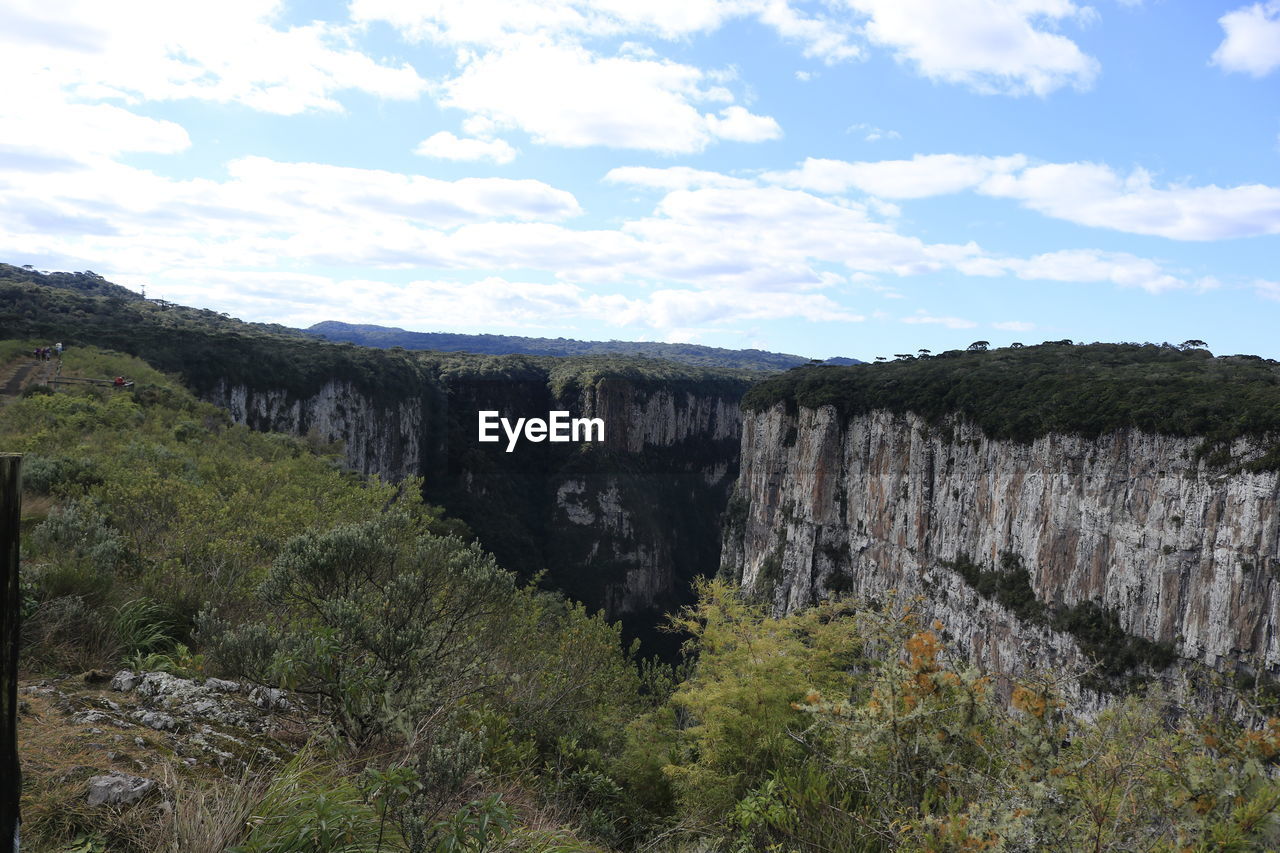 Scenic view of waterfall against sky