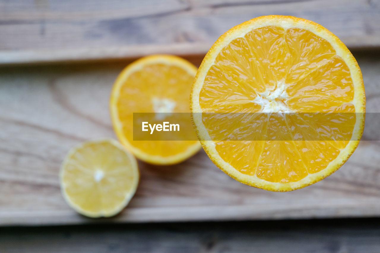 Close-up of oranges and lemon on table