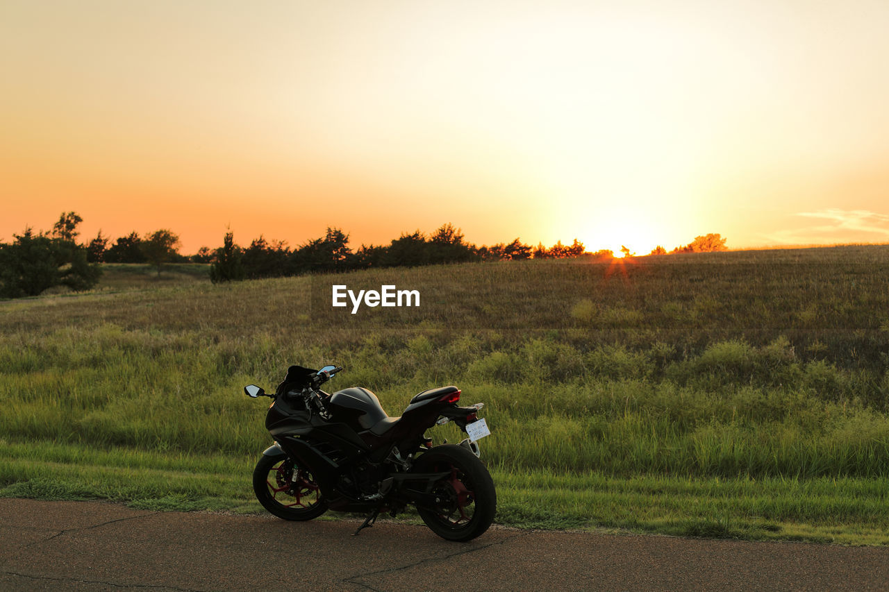 Scenic view of a field on a hill during a kansas sunset