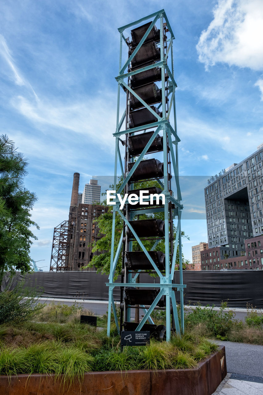 LOW ANGLE VIEW OF METALLIC STRUCTURE AGAINST SKY