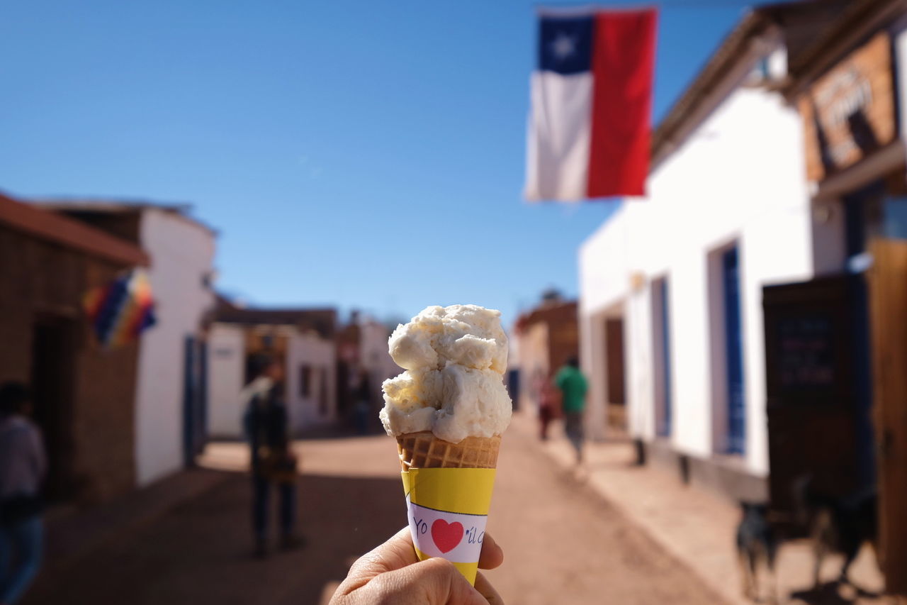 CLOSE-UP OF HAND HOLDING ICE CREAM