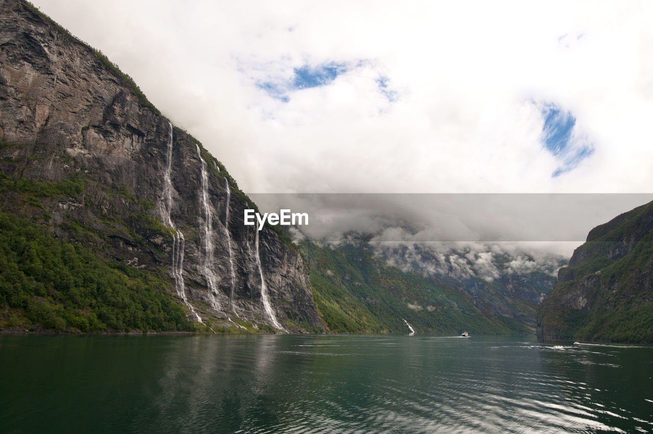 Scenic view of lake and mountains against sky