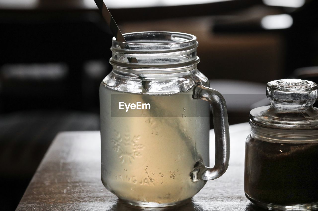 Close-up of drink in glass jar on table