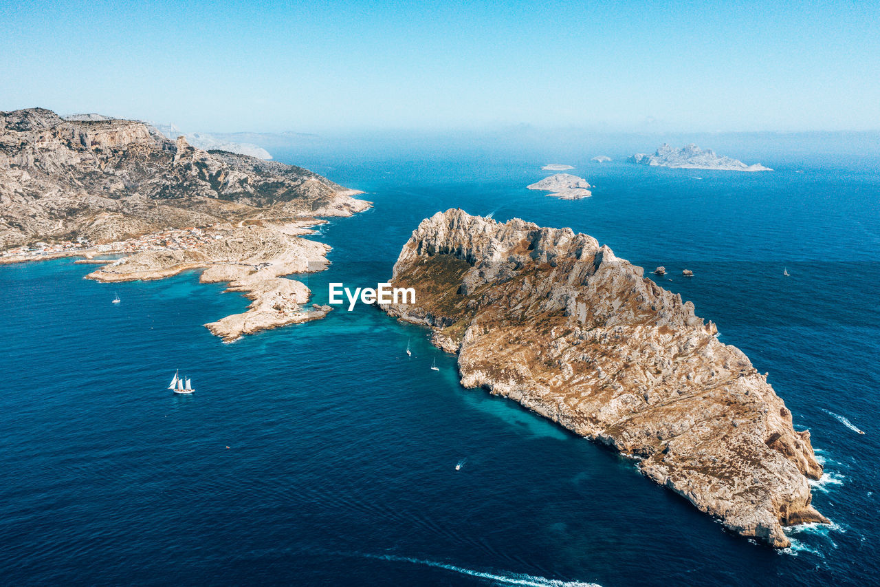 High angle view of rocks by sea against sky