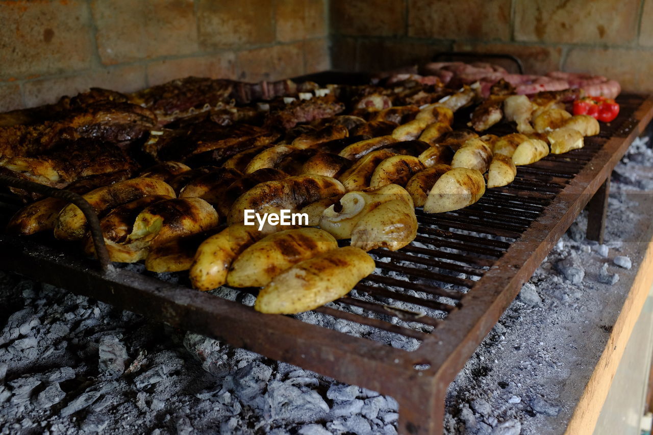 CLOSE-UP OF MEAT ON BARBECUE