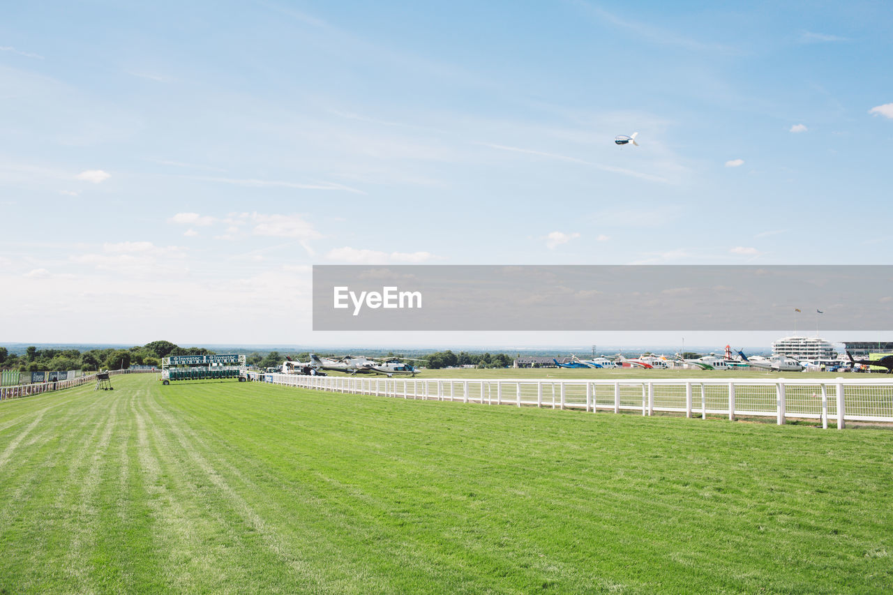 VIEW OF GRASSY FIELD AGAINST SKY