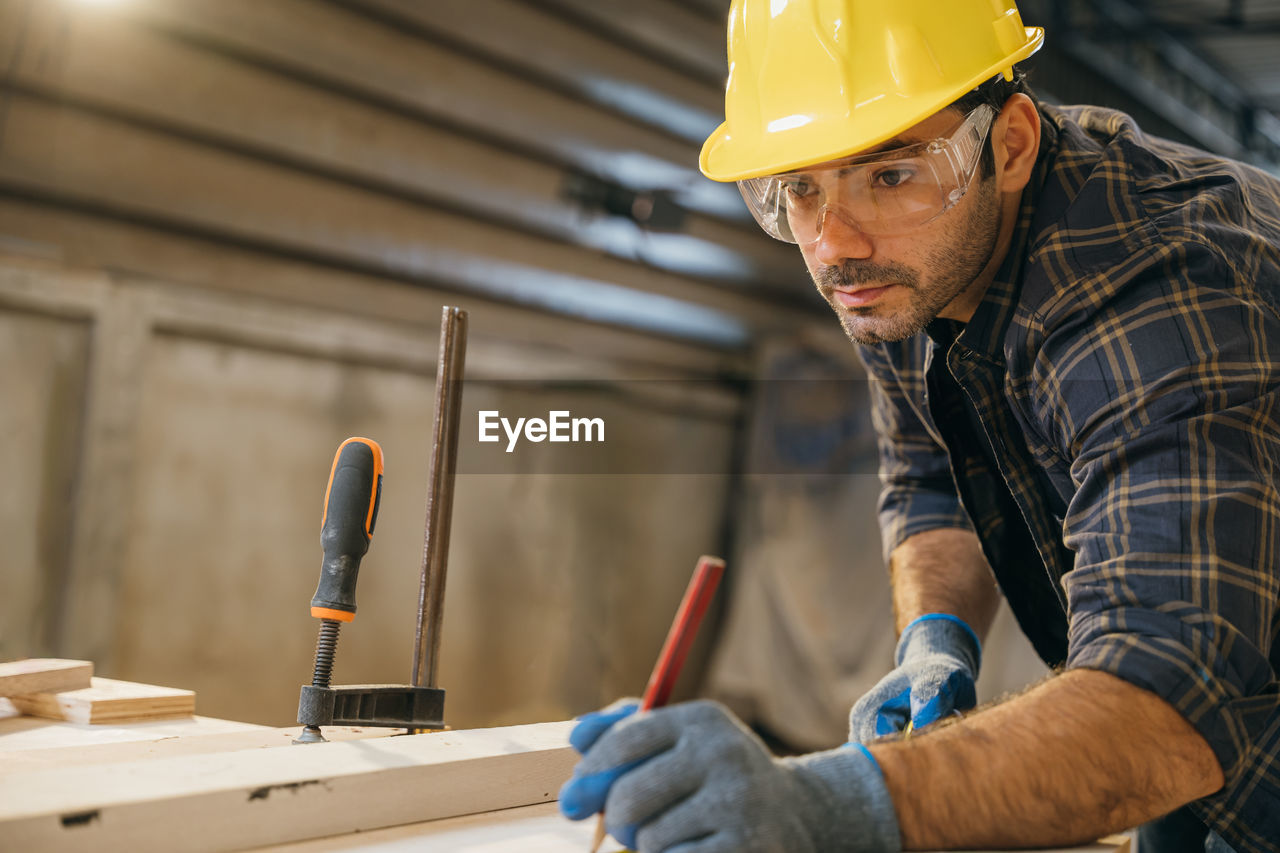 midsection of man working at workshop