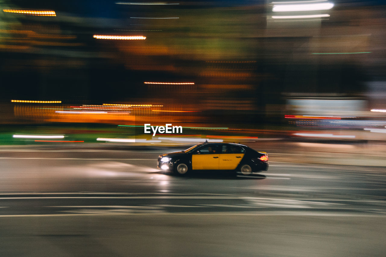 Car moving on illuminated road at night