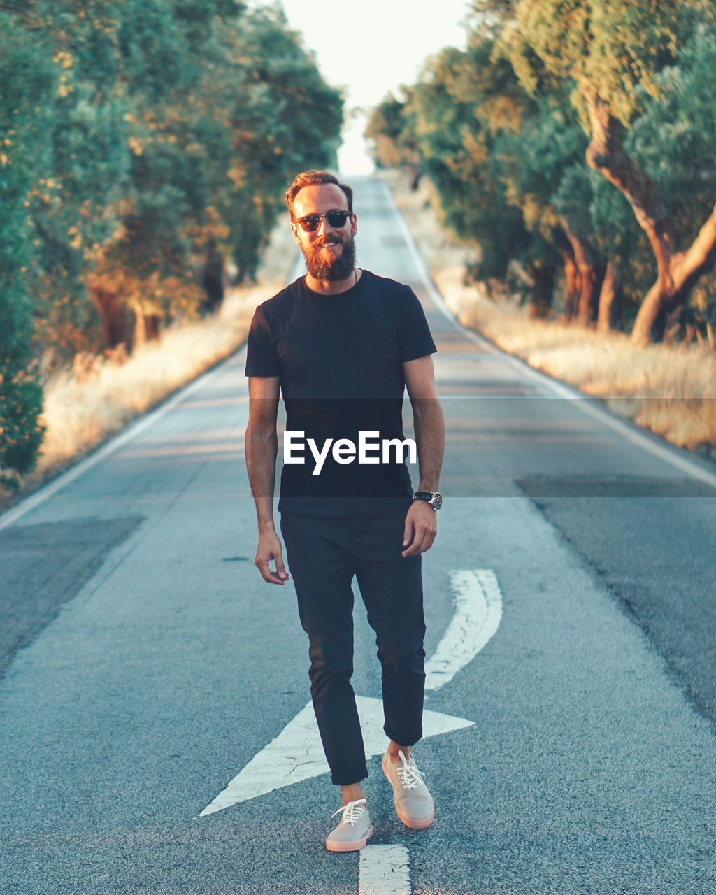 Full length of young man walking on road