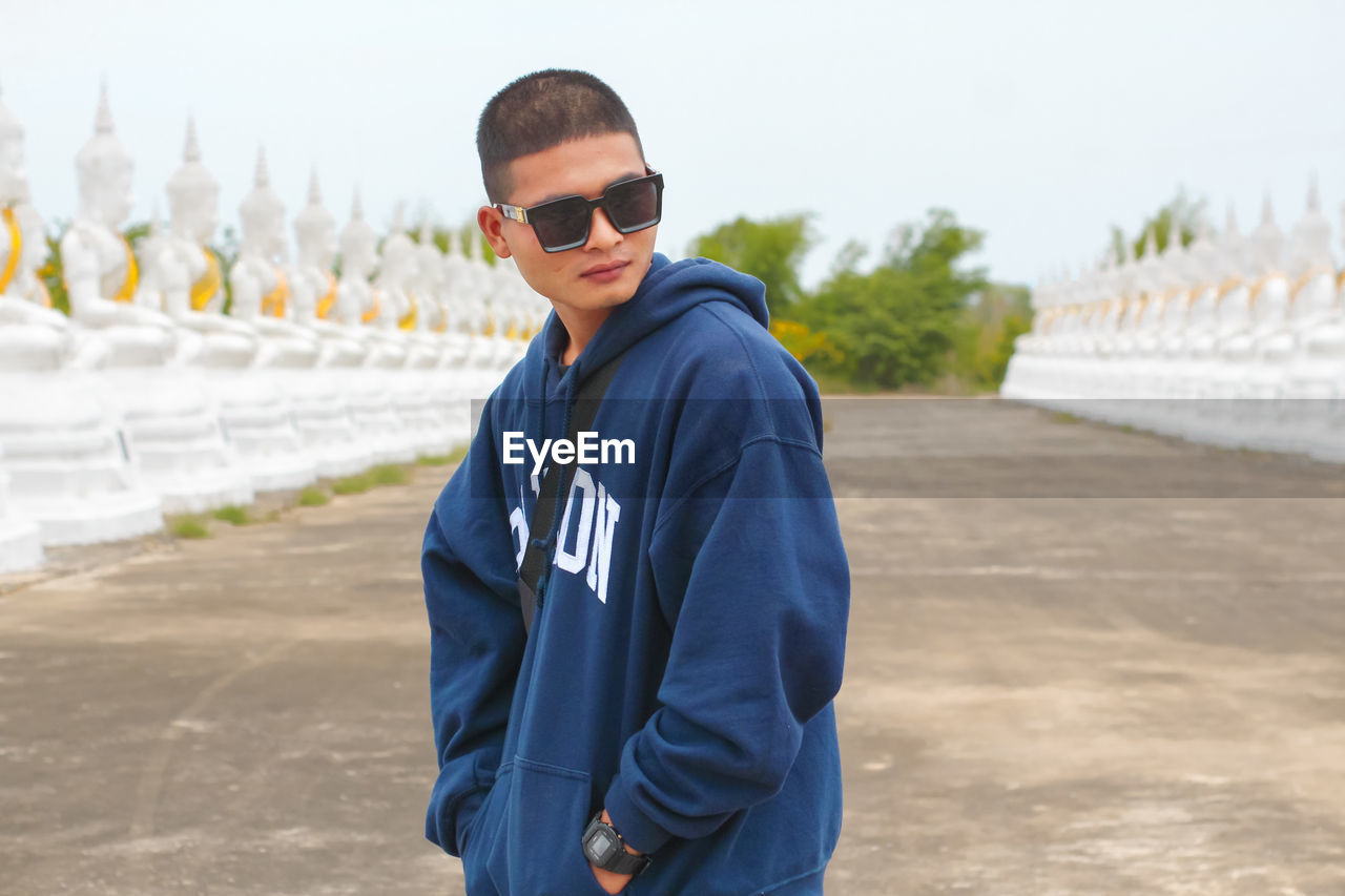 Portrait of a handsome young man standing outdoors