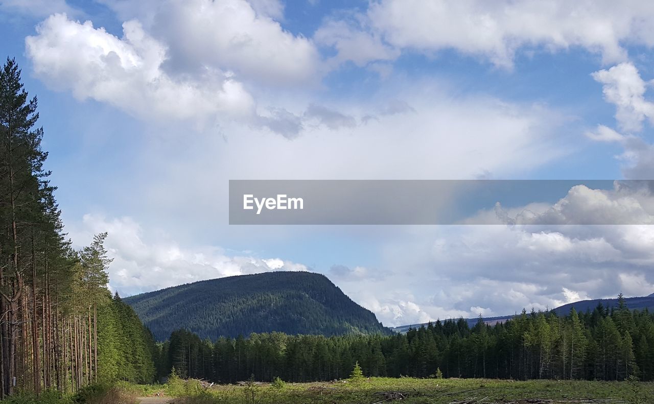 SCENIC VIEW OF MOUNTAINS AGAINST CLOUDY SKY