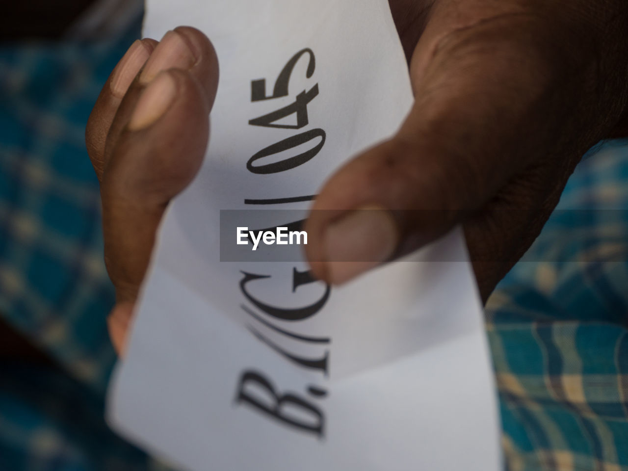 Close-up of human hand with paper