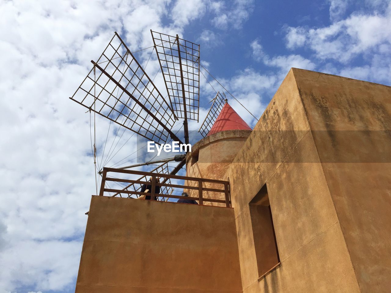 Low angle view of mill against sky