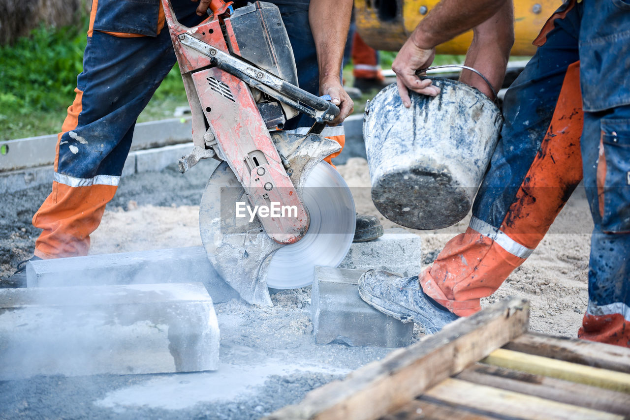 Low section of men working at construction site