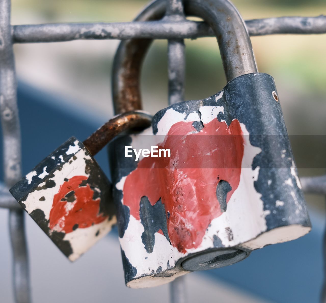 CLOSE-UP OF PADLOCKS ON METAL FENCE