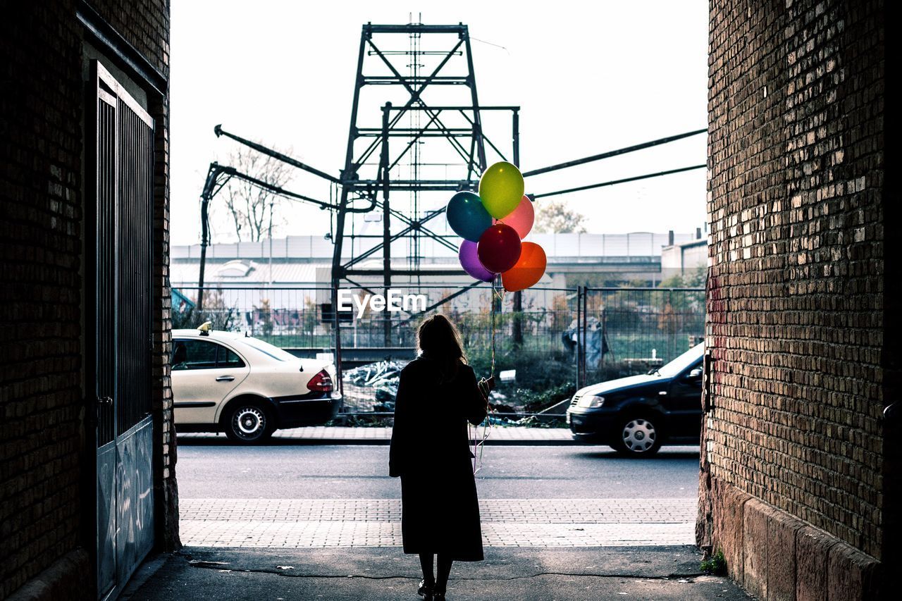 Woman with umbrella in tunnel