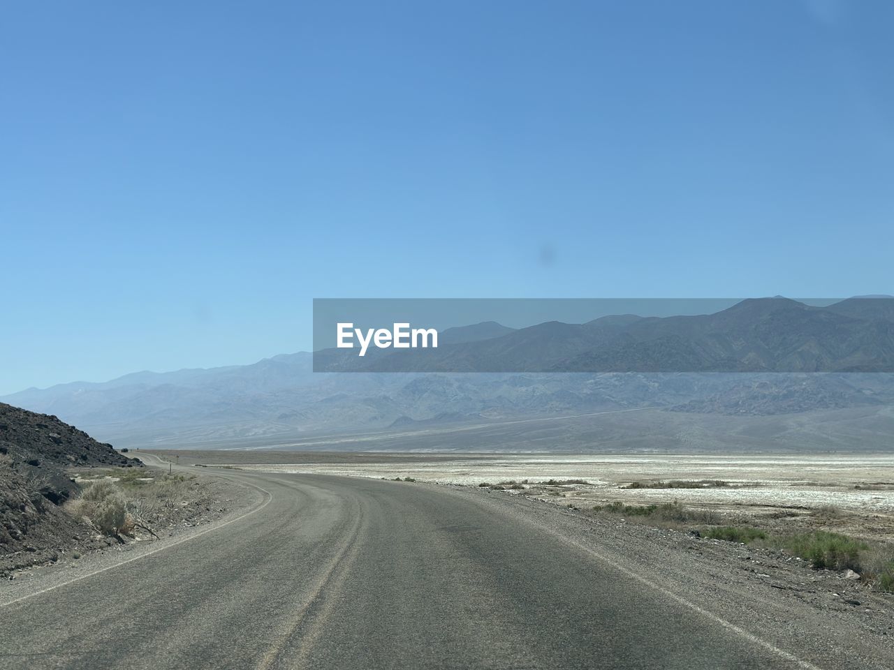 road, landscape, mountain, environment, sky, transportation, scenics - nature, horizon, nature, highway, the way forward, land, no people, mountain range, beauty in nature, road trip, blue, infrastructure, travel, desert, non-urban scene, remote, tranquility, clear sky, day, tranquil scene, plateau, diminishing perspective, vanishing point, plain, copy space, natural environment, travel destinations, valley, outdoors, empty road, dirt road, sunny, mountain pass, country road, empty, semi-arid, journey, arid climate, asphalt, absence