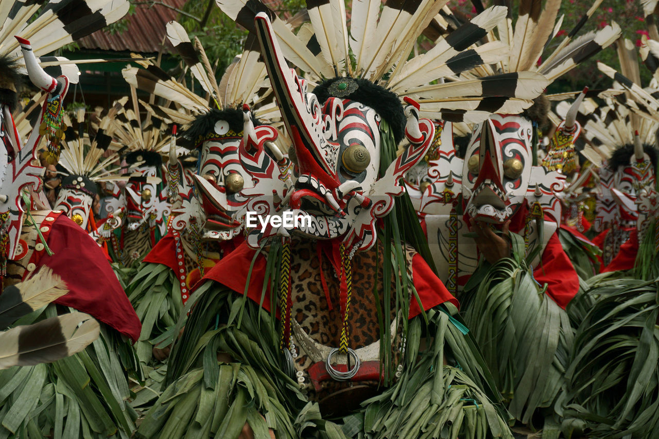 The scene of hudoq dancers marching in order to perform sacred rituals.