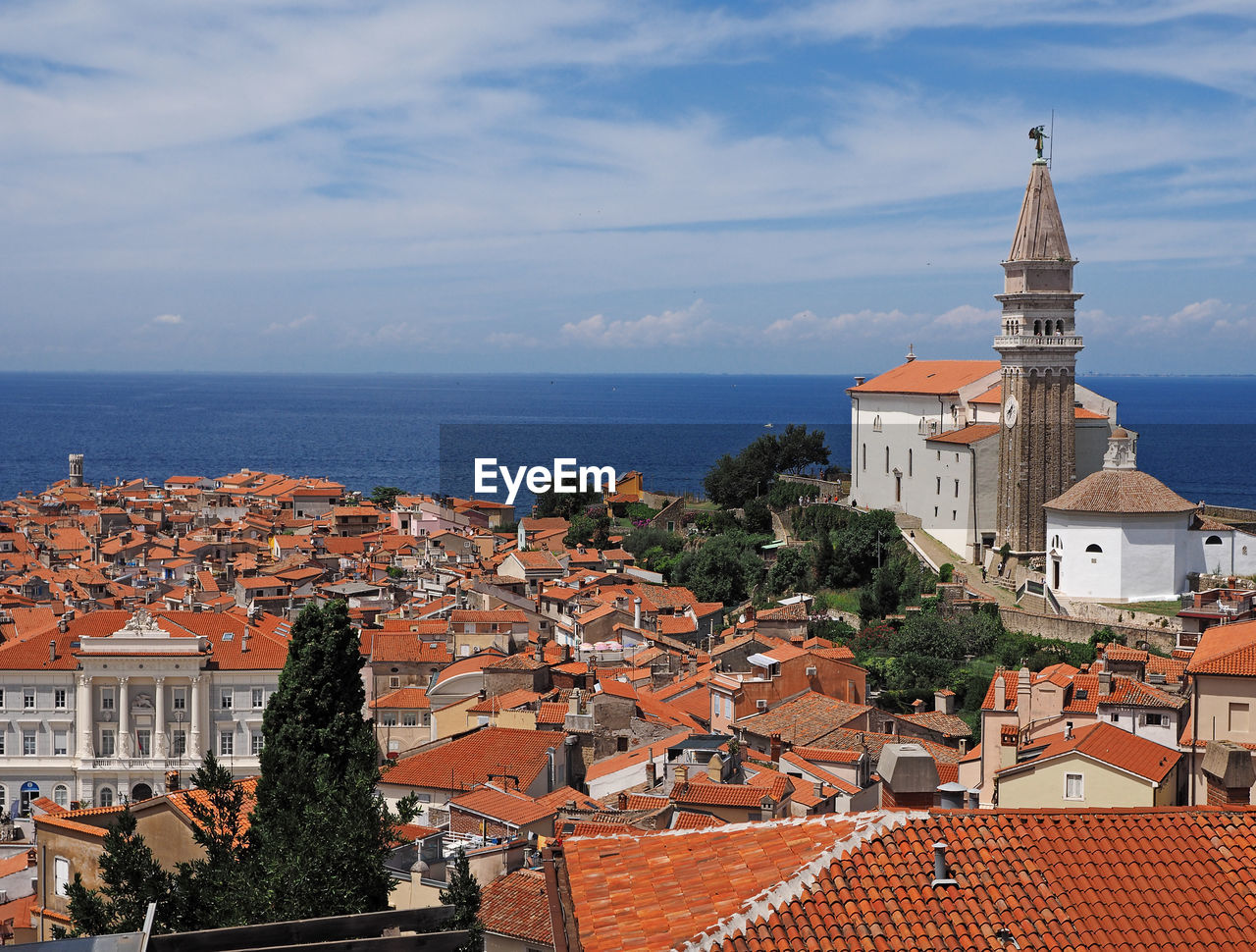 Traditional church by sea against sky