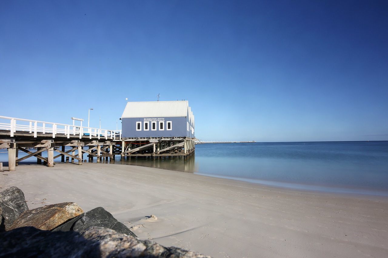 VIEW OF BEACH AGAINST CLEAR BLUE SKY