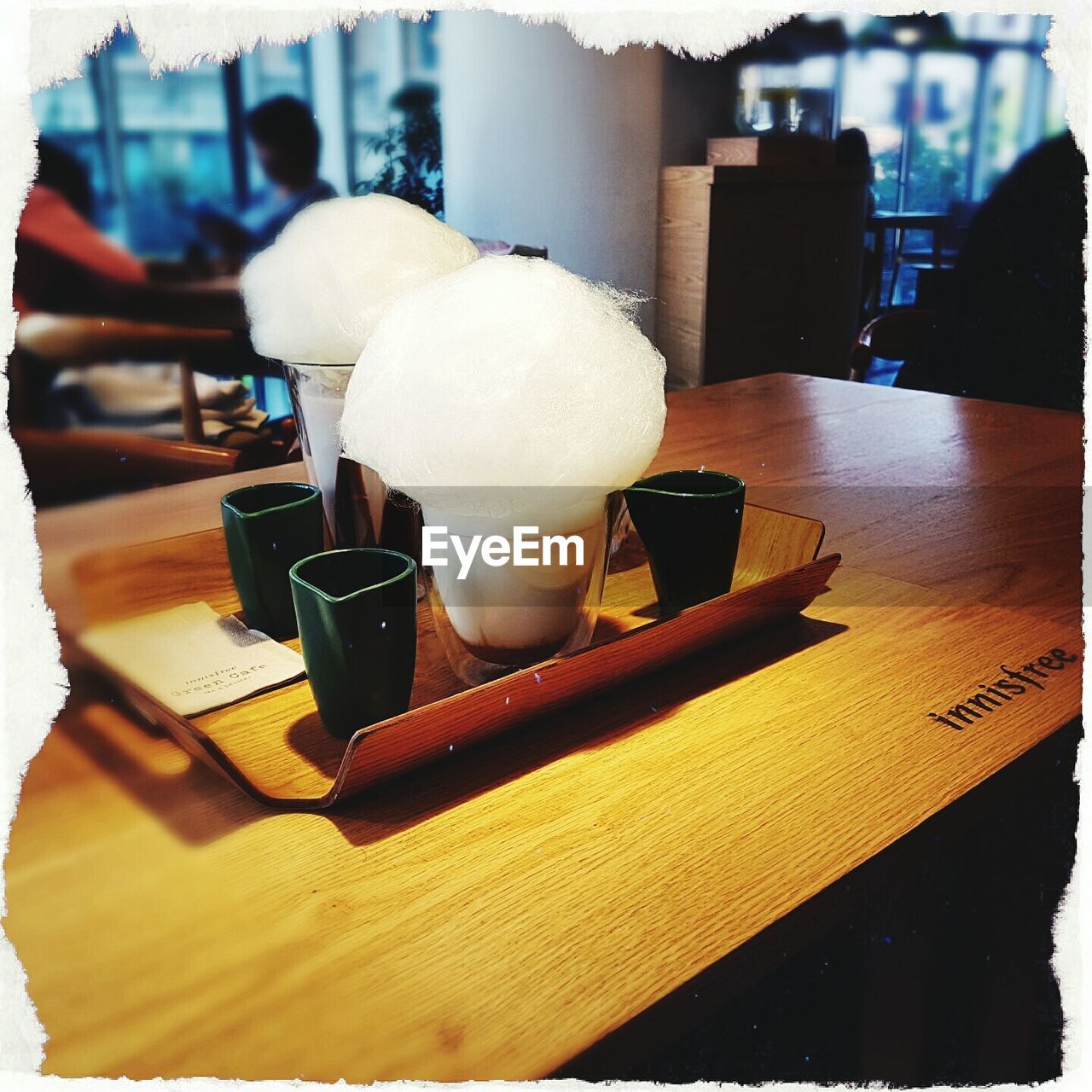 CLOSE-UP OF ICE CREAM IN PLATE ON TABLE