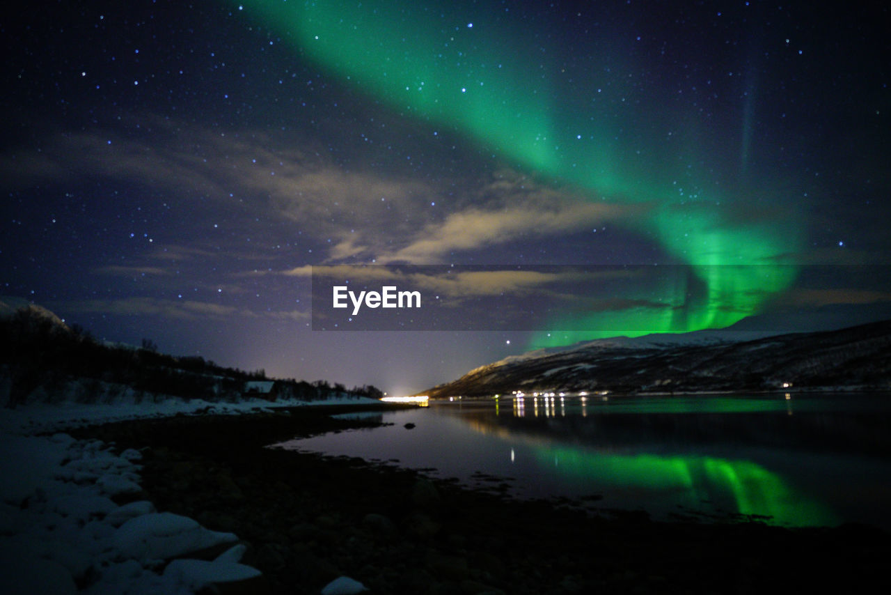 Scenic view of lake against sky at night