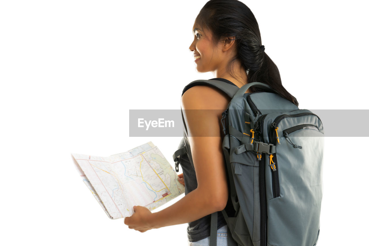 Female tourist with map against white background