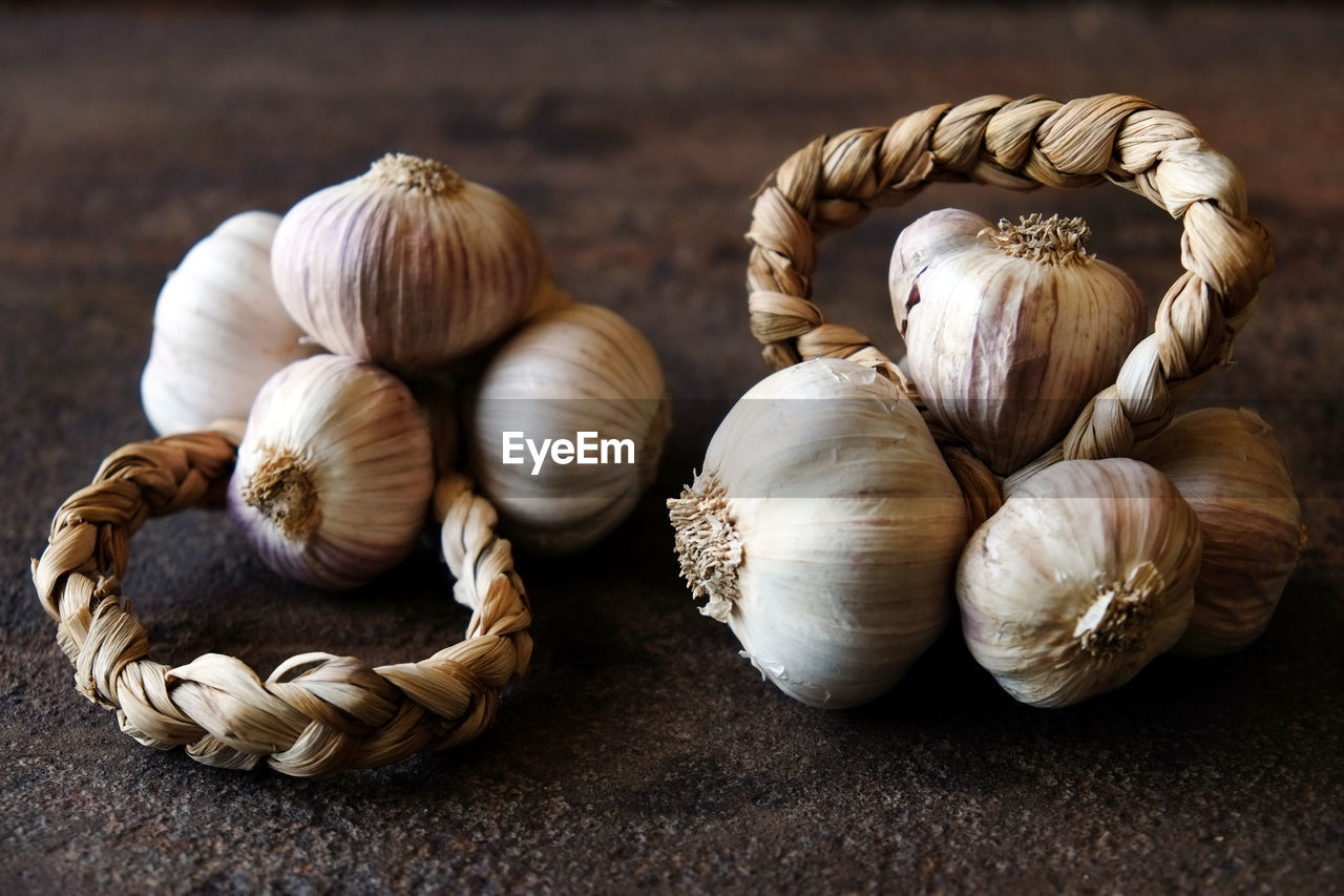 HIGH ANGLE VIEW OF GARLIC ON WHITE TABLE