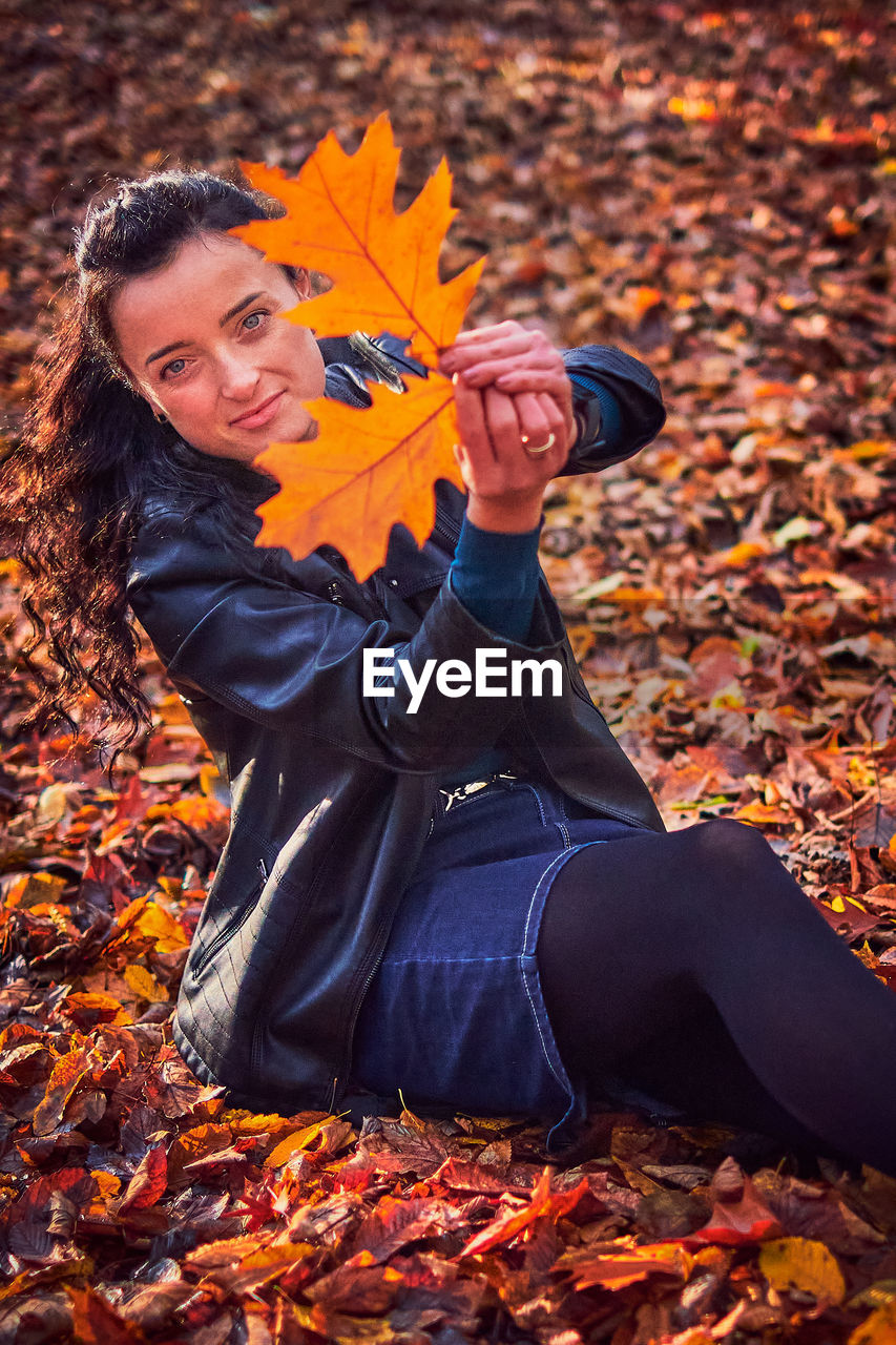 Portrait of woman with autumn leaves