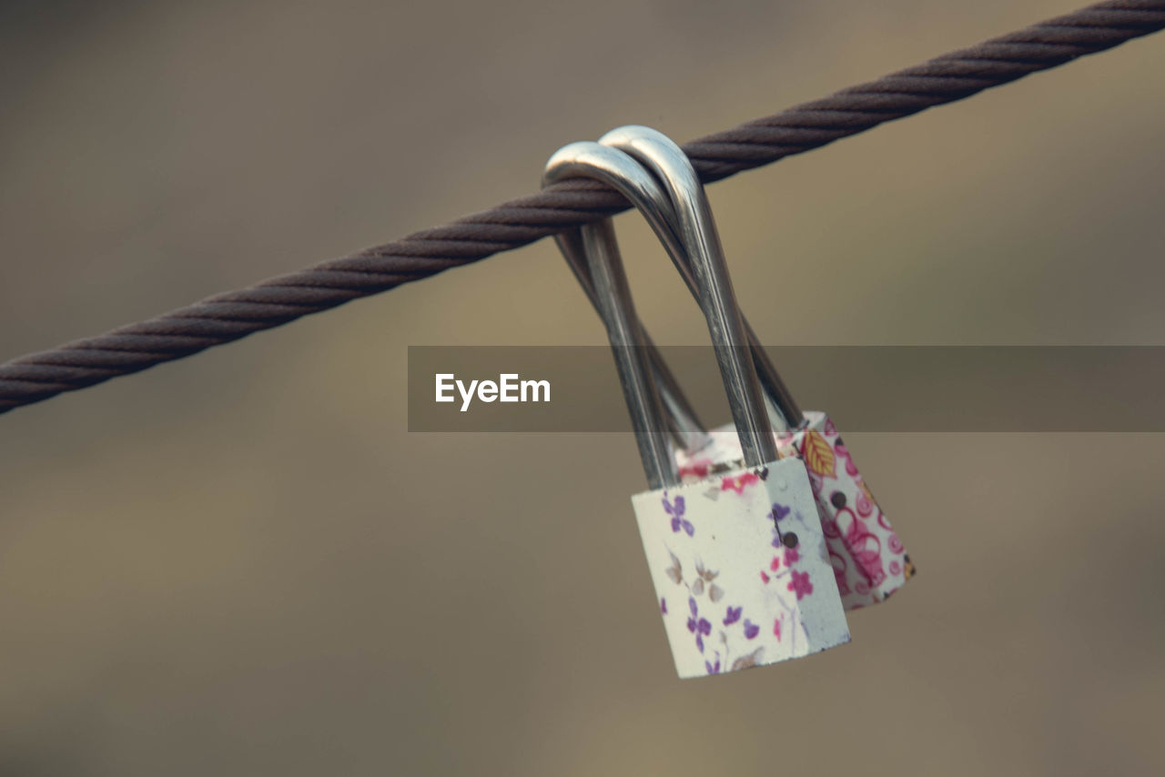 Close-up of padlocks attached to railing 