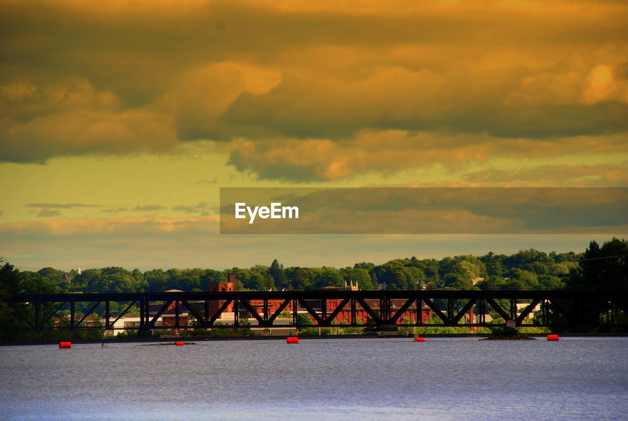 BRIDGE OVER RIVER AT SUNSET