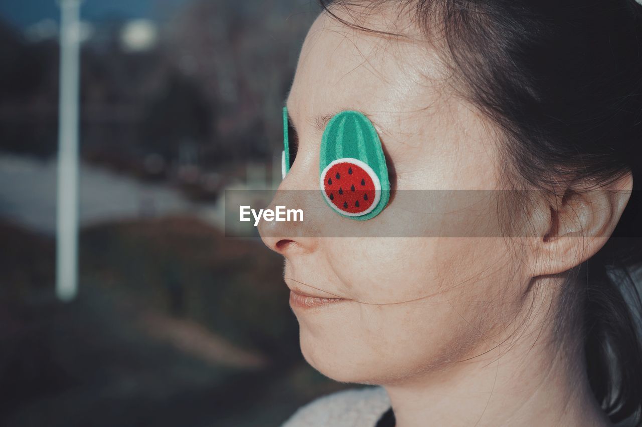 Close-up of woman wearing props on eyes