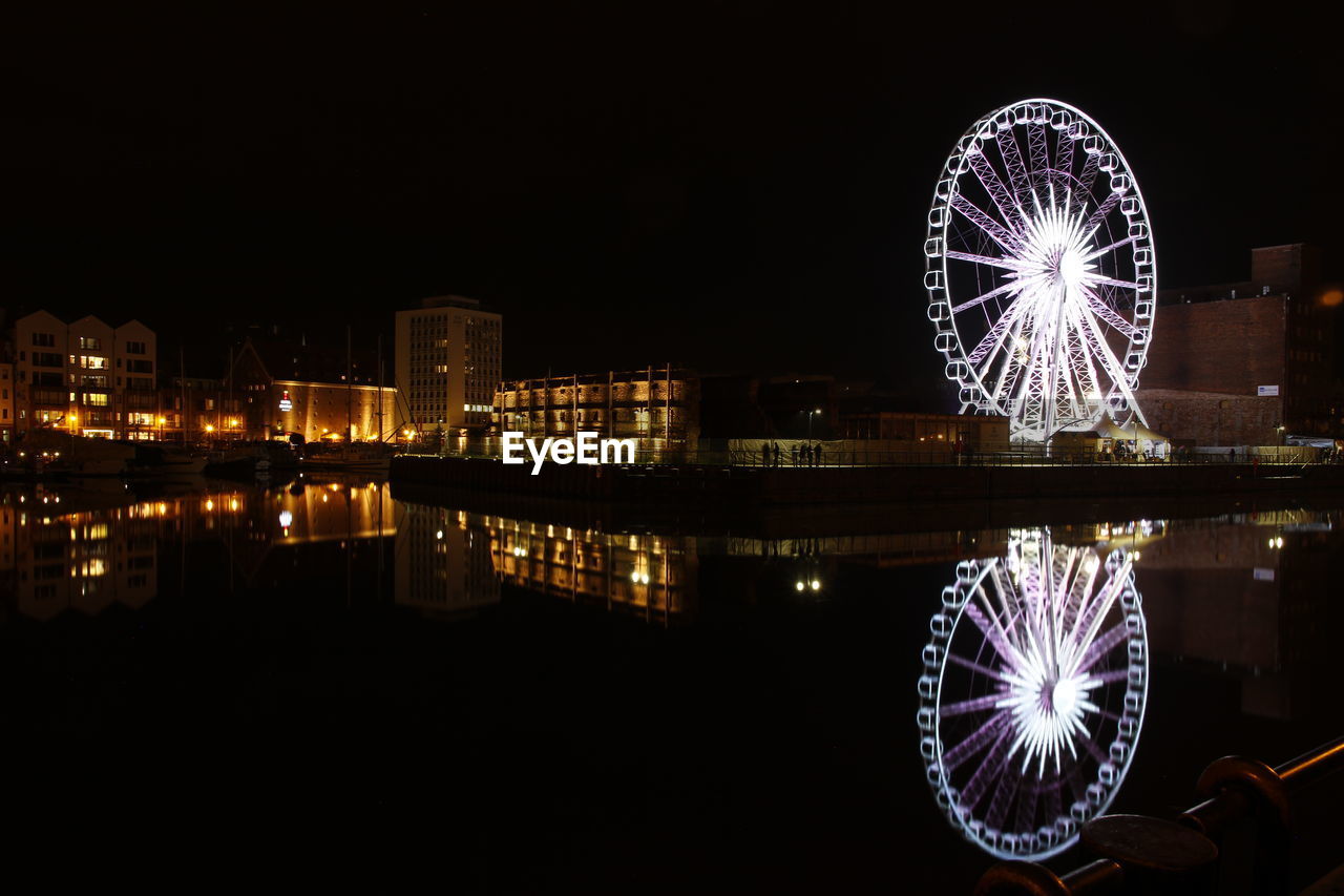 Illuminated ferris wheel at night