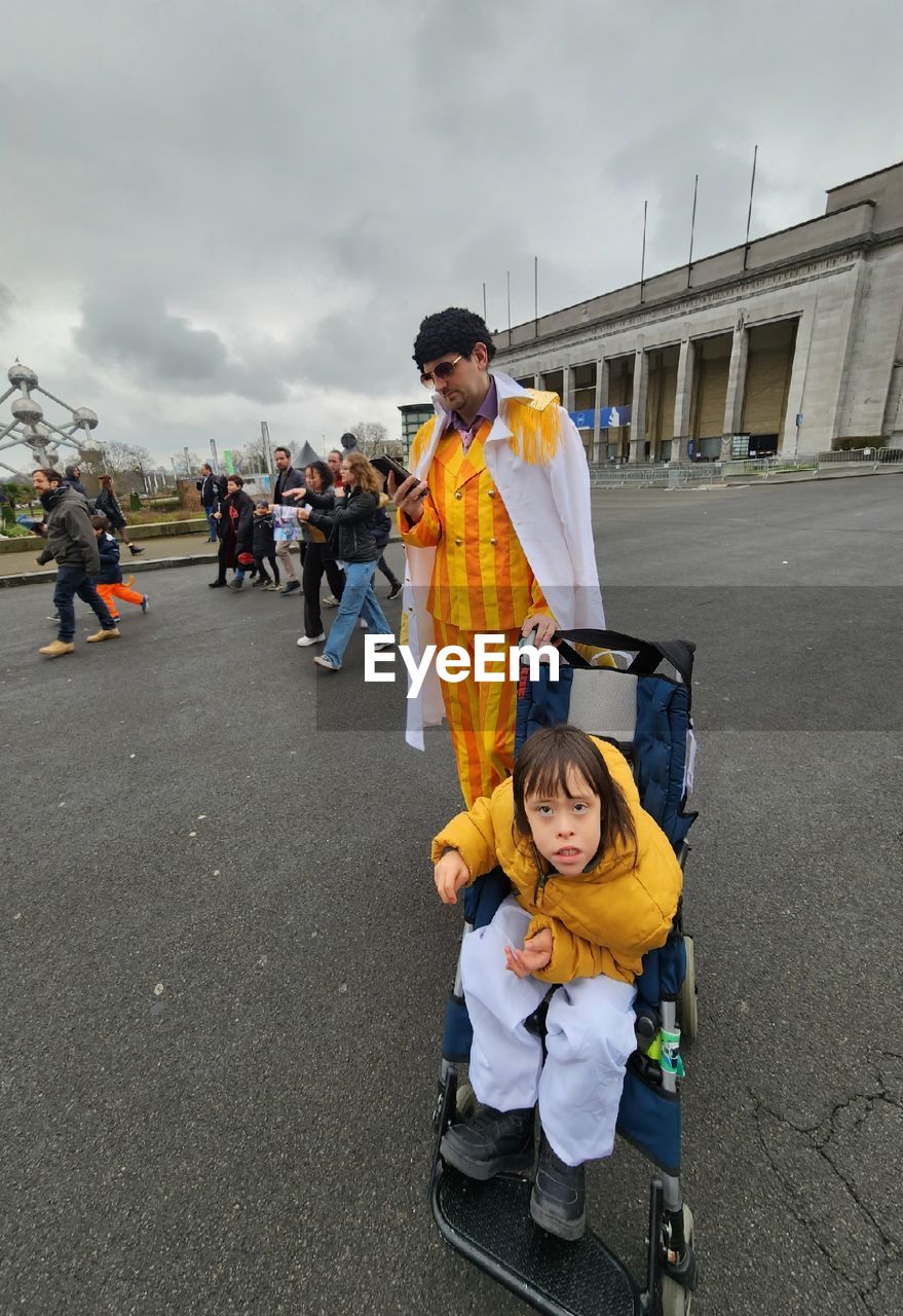 Portrait of man in kizaru cosplay with child in ninja cosplay