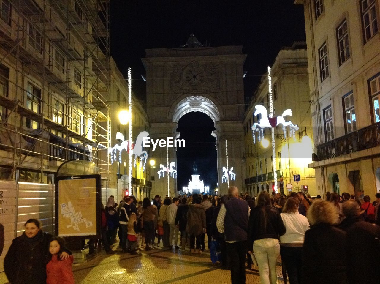 PEOPLE IN ILLUMINATED BUILDING