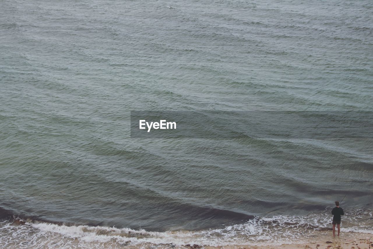 High angle view of man standing on beach