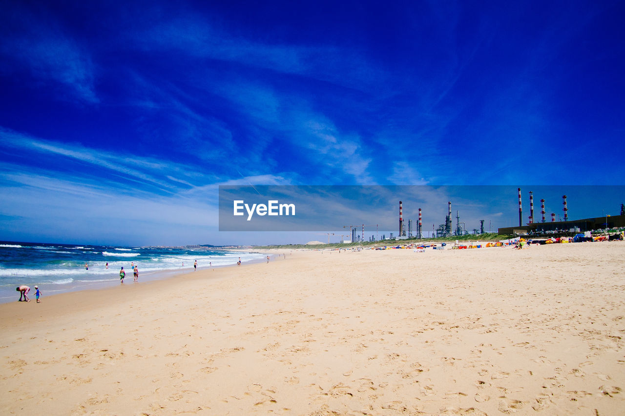 Scenic view of beach against blue sky