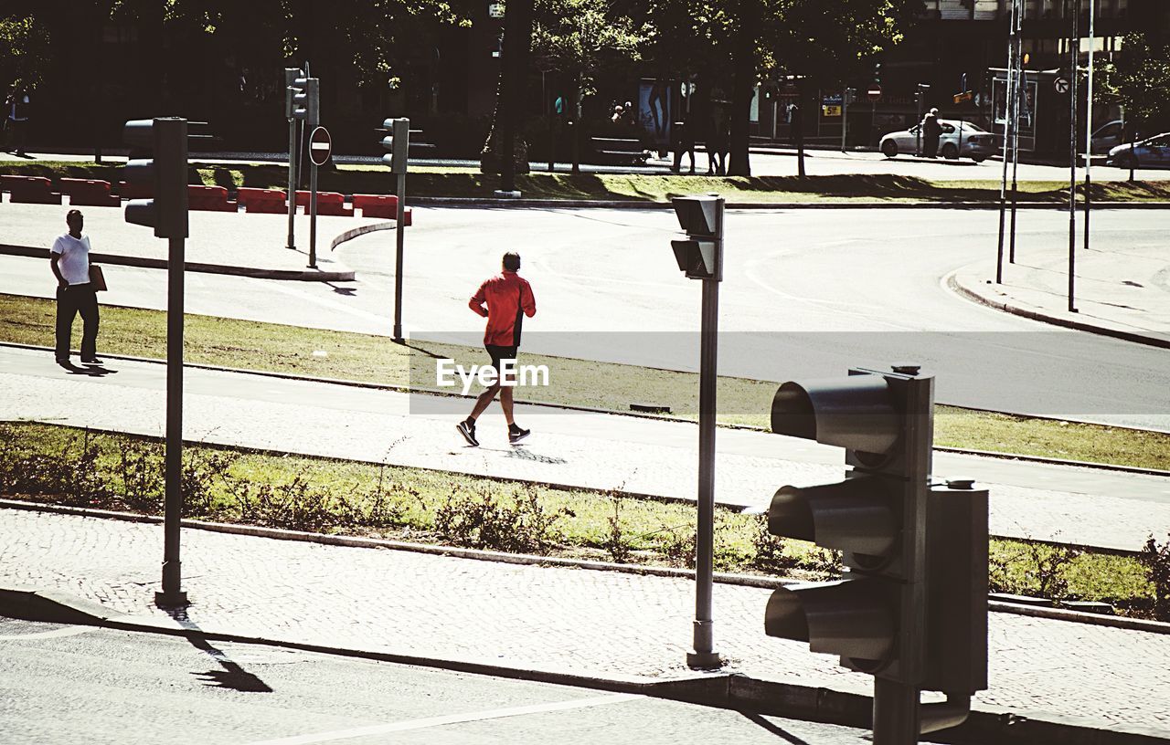 WOMAN WALKING ON ROAD