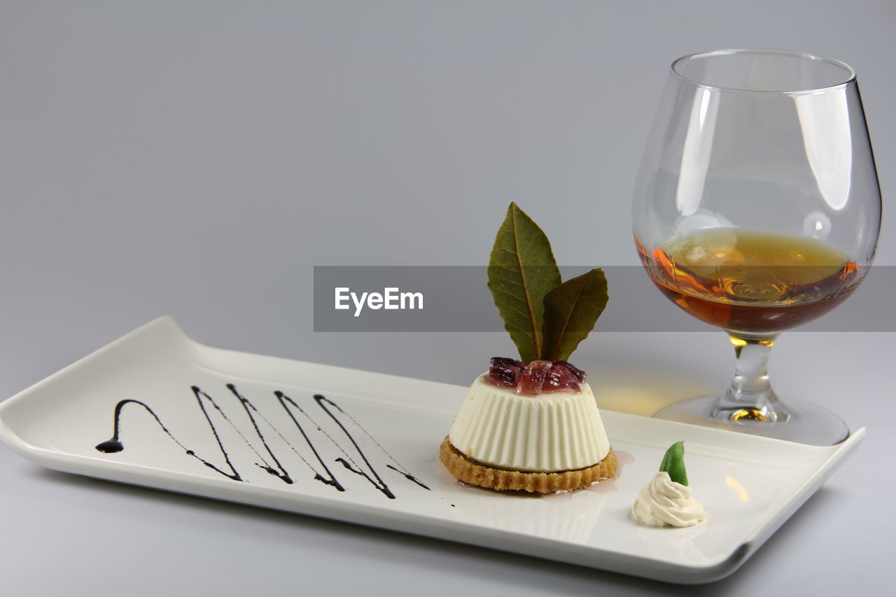 Wineglass and dessert on table