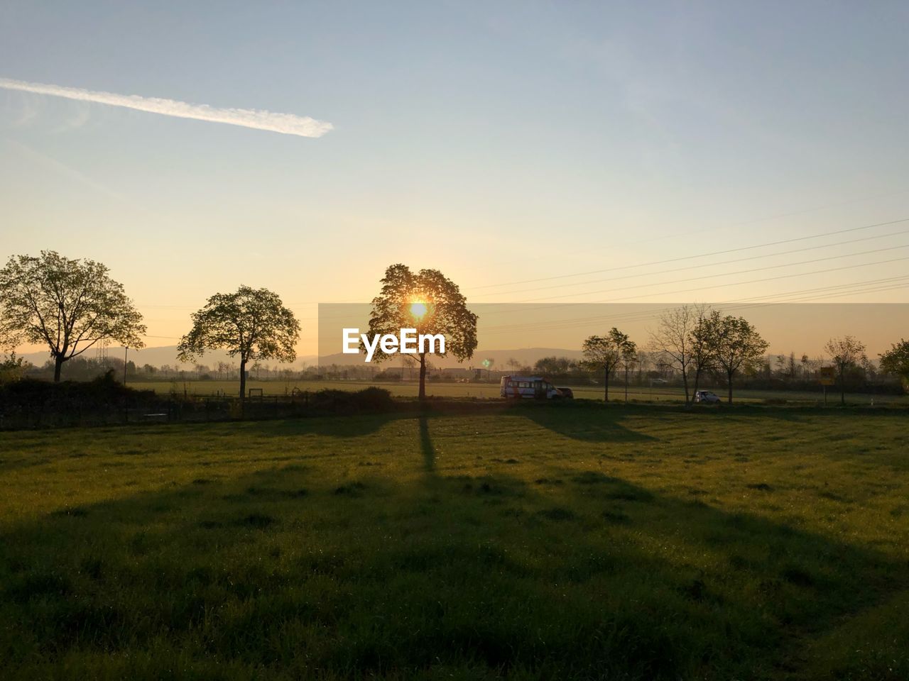 SCENIC VIEW OF FIELD AGAINST SKY DURING SUNSET