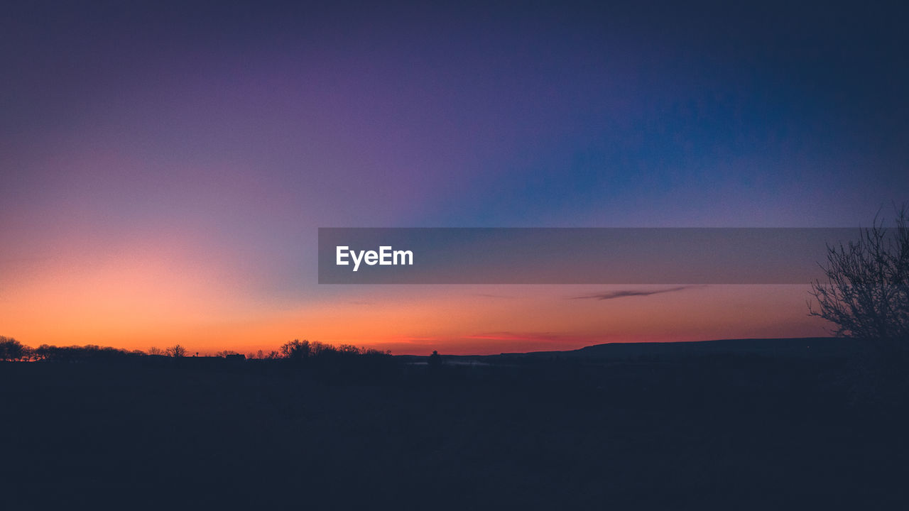 Scenic view of silhouette landscape against sky during sunset