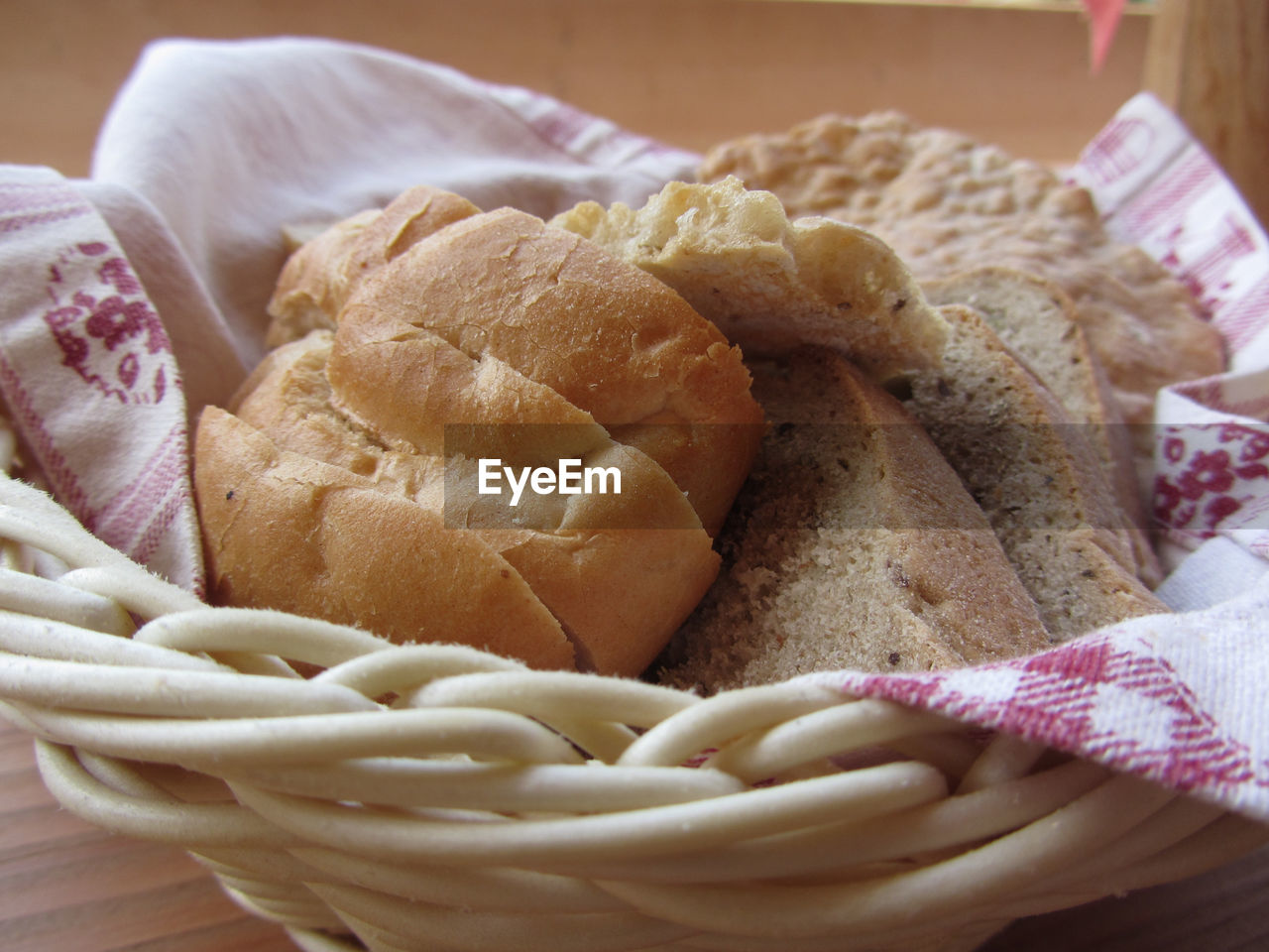 Assortment of baked bread and bun in a wicker basket