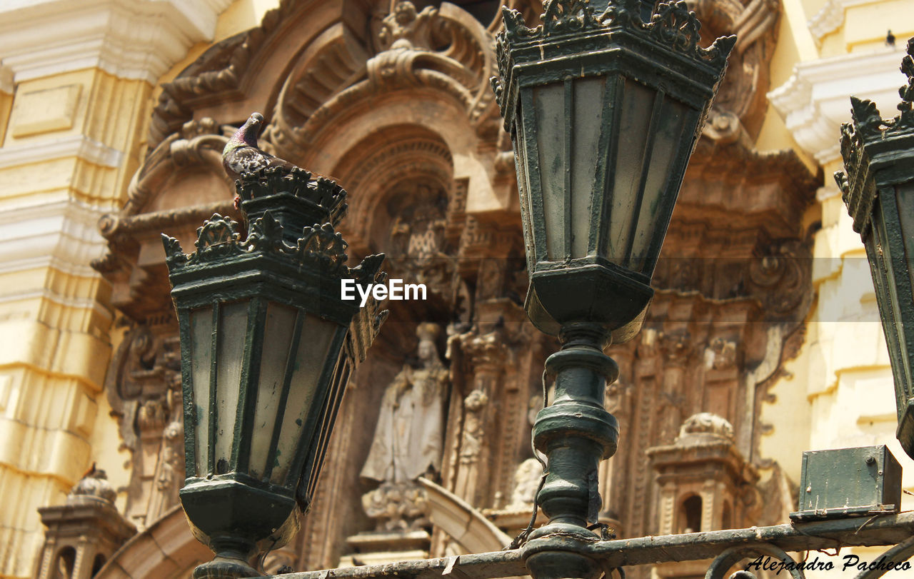 Low angle view of lighting equipment against saint francis monastery