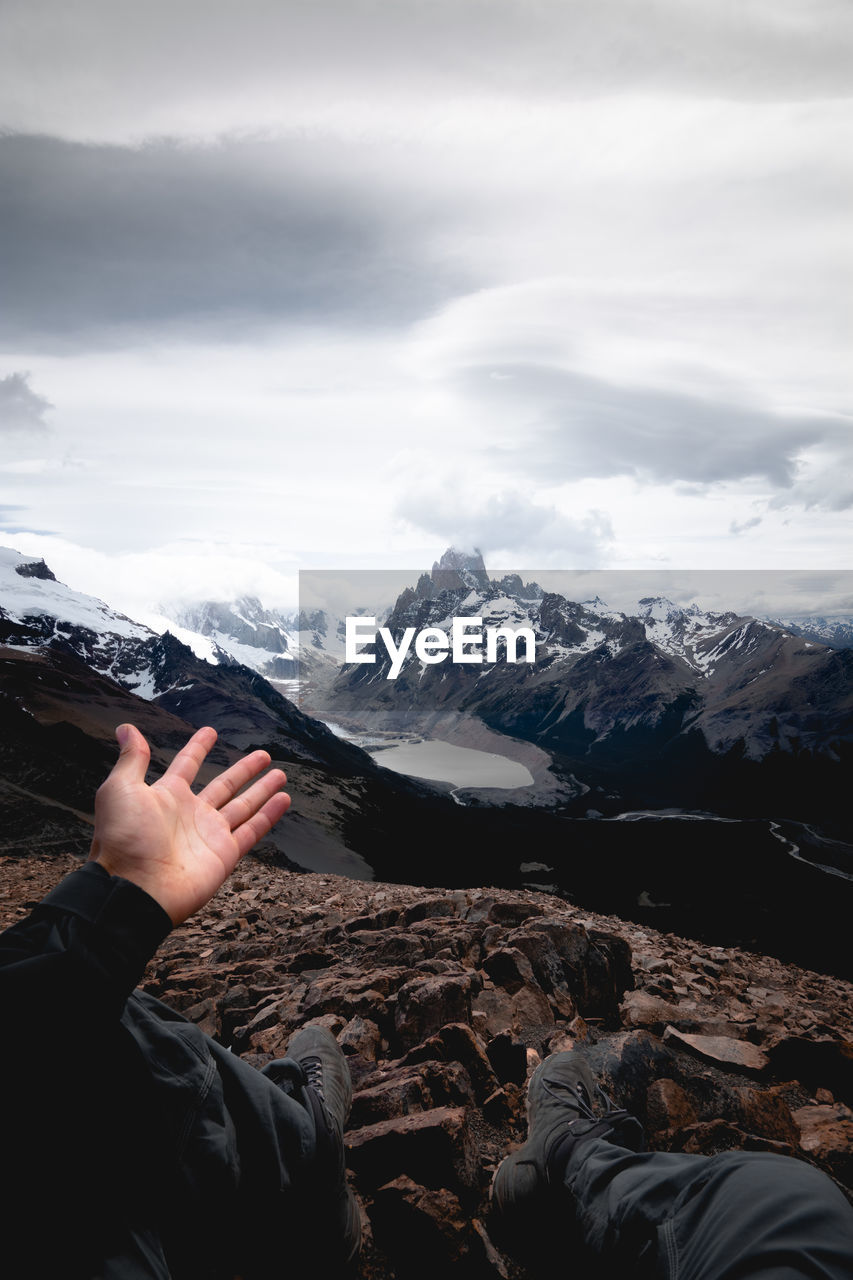 Woman on snowcapped mountain against sky