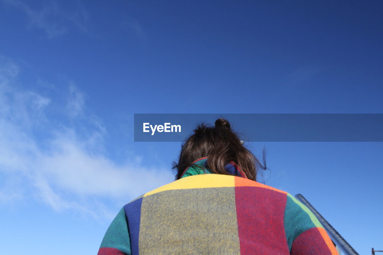 Rear view of woman against sky
