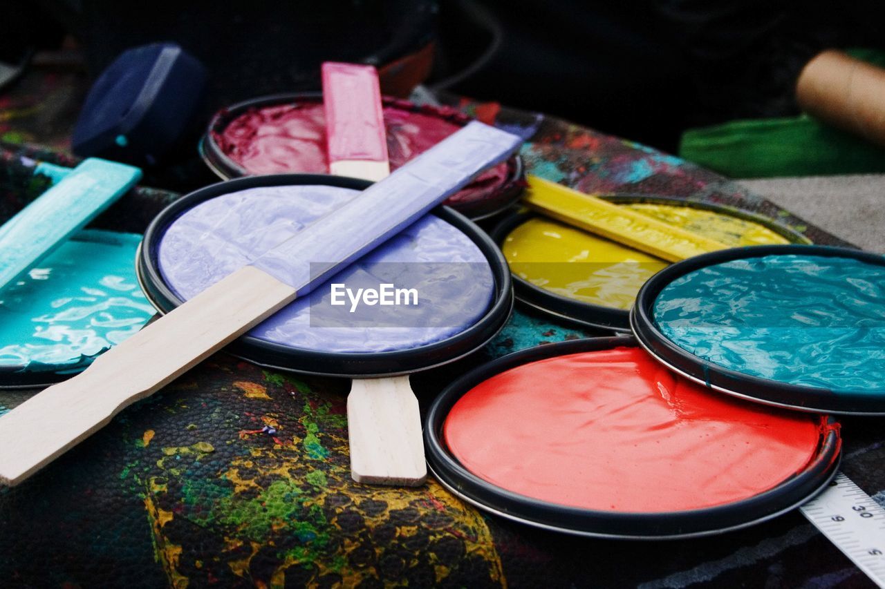 Close-up of paint can lids on table