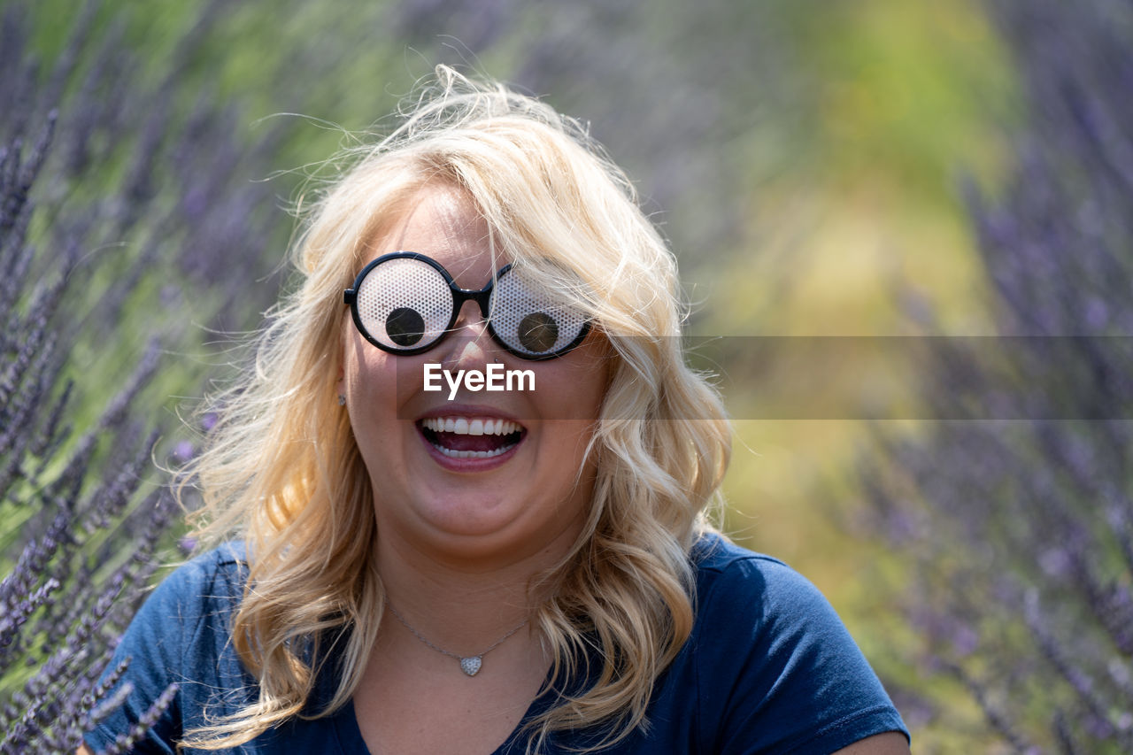 Smiling woman wearing novelty glasses