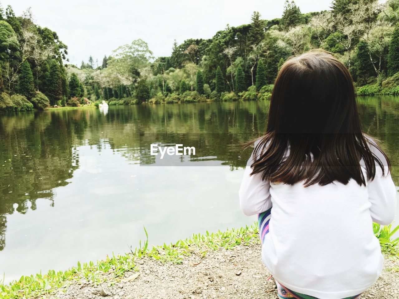 REAR VIEW OF TWO WOMEN IN LAKE