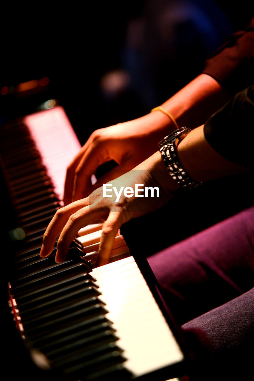 Close-up of woman playing piano