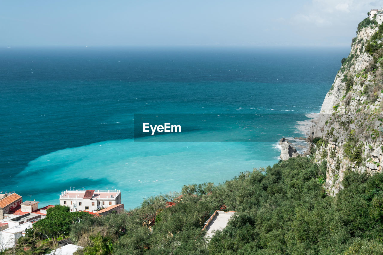 Scenic view of sea by mountain